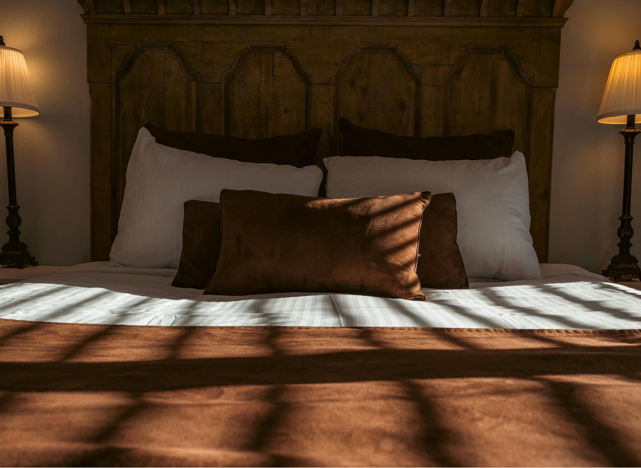 A quietly kept bedroom at golden hour